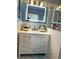 Modern bathroom featuring a lighted mirror, shaker cabinets, and a bright, clean design at 655 Vine Ct, Apopka, FL 32703