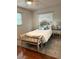 Comfortable bedroom featuring a cushioned headboard, accent pillows, and a stylish bench at 655 Vine Ct, Apopka, FL 32703