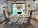 Elegant dining area with stylish furnishings, a large window overlooking the pool, and modern decor at 655 Vine Ct, Apopka, FL 32703