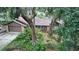 Exterior front view of a single-story home featuring a brick facade and an attached garage with mature landscaping at 655 Vine Ct, Apopka, FL 32703