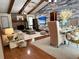 Open-concept living room with vaulted ceilings, wood beams, fireplace and stylish decor for relaxing and entertaining at 655 Vine Ct, Apopka, FL 32703