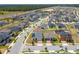 Aerial view of a home with solar panels located in a well-planned residential community at 6651 Syreeta Ln, Harmony, FL 34773
