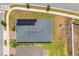 Aerial view of a home's roof featuring solar panels, landscaping, and proximity to neighborhood streets at 6651 Syreeta Ln, Harmony, FL 34773