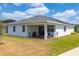 View of a charming backyard patio with a grill and lounge chairs, perfect for outdoor relaxation and entertaining at 6651 Syreeta Ln, Harmony, FL 34773