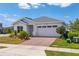 Well-maintained single Gathering home featuring a two-car garage and neatly landscaped front yard at 6651 Syreeta Ln, Harmony, FL 34773