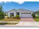 Charming single-story home with manicured landscaping and a brick paver driveway at 6651 Syreeta Ln, Harmony, FL 34773