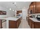 Modern kitchen featuring an island, stainless steel appliances, and ample cabinet space at 6651 Syreeta Ln, Harmony, FL 34773
