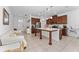 Open concept kitchen with an island and a view of the entryway and dining area at 6651 Syreeta Ln, Harmony, FL 34773