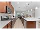 Open kitchen featuring a large island, stainless steel appliances, and seamless access to the dining area at 6651 Syreeta Ln, Harmony, FL 34773