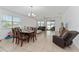 Open-concept living room and dining area with tile flooring and natural light at 6651 Syreeta Ln, Harmony, FL 34773