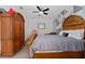 Bedroom with wooden furniture, including a bed, armoire, and an accent wall at 6651 Syreeta Ln, Harmony, FL 34773