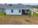 This home's rear exterior features an attractive covered patio and well-maintained lawn at 6651 Syreeta Ln, Harmony, FL 34773
