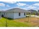 View of a home's exterior showcases the yard, siding, and roof of the property at 6651 Syreeta Ln, Harmony, FL 34773