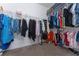 Spacious walk-in closet with ample shelving and hanging space for optimal organization of clothes, shoes, and accessories at 6651 Syreeta Ln, Harmony, FL 34773