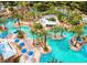 A beautiful aerial view of resort-style swimming pools surrounded by palm trees and lounge chairs at 7773 Spectrum Dr, Reunion, FL 34747