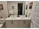 Bright bathroom with double sinks, a large mirror, and modern fixtures, offering a clean and functional space at 7773 Spectrum Dr, Reunion, FL 34747
