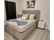 Inviting bedroom with a plush bed, decorative pillows, and soft lighting, creating a cozy and relaxing space at 7773 Spectrum Dr, Reunion, FL 34747