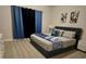 Comfortable bedroom with stylish blue accents, soft carpet, and ample lighting for a peaceful retreat at 7773 Spectrum Dr, Reunion, FL 34747