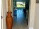 Bright foyer with a view to the outdoors with elegant decor and sleek tile flooring, creating an inviting entrance at 7773 Spectrum Dr, Reunion, FL 34747