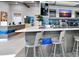 Modern kitchen with bar seating, and sleek appliances at 7773 Spectrum Dr, Reunion, FL 34747