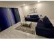 Cozy living room features plush blue sofas, a glass coffee table, and neutral decor for a relaxing atmosphere at 7773 Spectrum Dr, Reunion, FL 34747