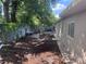 Exterior view showing the side and back of the house plus the backyard's mature trees at 822 5Th St, Orlando, FL 32824