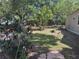 Green backyard with a lush lawn, trees, and some flowerbeds at 822 5Th St, Orlando, FL 32824
