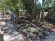 Lush backyard with potential, featuring mature trees and some existing hardscape at 822 5Th St, Orlando, FL 32824