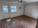 Spacious bedroom with a ceiling fan, a door to the outside, wood flooring and plenty of light at 822 5Th St, Orlando, FL 32824