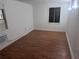 This bedroom features modern vinyl floors, a window, and an air conditioning unit at 822 5Th St, Orlando, FL 32824