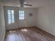A bright and airy bedroom with new vinyl flooring and a door to the outdoors at 822 5Th St, Orlando, FL 32824