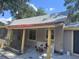 A cozy single-story home with a red awning and yellow support beams, surrounded by greenery at 822 5Th St, Orlando, FL 32824