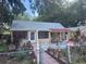 Exterior shot of a home, showcasing the front entrance and simple yard at 822 5Th St, Orlando, FL 32824
