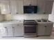 Modern kitchen with stainless steel appliances, granite counters, and neutral color cabinetry at 822 5Th St, Orlando, FL 32824