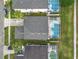 Aerial view of a property with a screened-in pool, manicured lawn and driveway with parking at 824 Bloomingdale Dr, Davenport, FL 33897