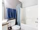 Bright bathroom featuring a bathtub with shower and a set of blue towels at 824 Bloomingdale Dr, Davenport, FL 33897