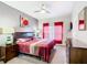 Bedroom featuring neutral walls, an ornate headboard, and a window with blinds and curtains at 824 Bloomingdale Dr, Davenport, FL 33897