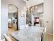 Elegant dining room featuring a chandelier, large marble table, and archways leading to other living areas at 824 Bloomingdale Dr, Davenport, FL 33897