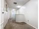 Bright hallway with carpeted floors leading to various rooms in the house at 824 Bloomingdale Dr, Davenport, FL 33897