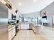 Bright kitchen features stainless appliances, white cabinets, granite countertops, and center island at 824 Bloomingdale Dr, Davenport, FL 33897