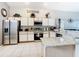 Spacious kitchen with stainless steel appliances, island and white cabinetry at 824 Bloomingdale Dr, Davenport, FL 33897