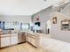 Open concept kitchen with stainless steel appliances, island and view of the stairs at 824 Bloomingdale Dr, Davenport, FL 33897