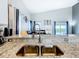 Modern kitchen sink with granite countertops overlooking the living area and pool view at 824 Bloomingdale Dr, Davenport, FL 33897