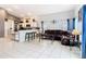 Open concept living room with view of the kitchen, featuring a leather sectional and tiled floors at 824 Bloomingdale Dr, Davenport, FL 33897
