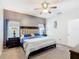 Cozy bedroom featuring a large bed, soft carpet, ceiling fan, and windows providing natural light at 824 Bloomingdale Dr, Davenport, FL 33897