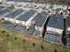 Aerial shot showing the property with a screened pool, adjacent to similar residences in a well-maintained community at 8974 Cabot Cliffs Dr, Davenport, FL 33896