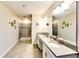 Bright primary bathroom featuring a double sink vanity and glass shower enclosure at 8974 Cabot Cliffs Dr, Davenport, FL 33896