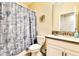 Bathroom with a single sink vanity and seashell-themed shower curtain at 8974 Cabot Cliffs Dr, Davenport, FL 33896