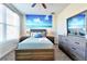 Nicely decorated bedroom featuring an accent wall with an ocean mural at 8974 Cabot Cliffs Dr, Davenport, FL 33896