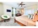 Cozy bedroom with a ceiling fan, TV, accent chair, and stylish decor at 8974 Cabot Cliffs Dr, Davenport, FL 33896